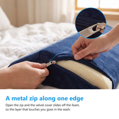 Two hands opening the metal zip on the navy velvet cover of the wedge cushion with the cream memory foam visible inside