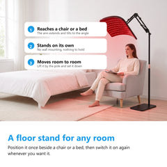 Woman sitting in an armchair in a white bedroom beside a red light therapy lamp on its floor stand