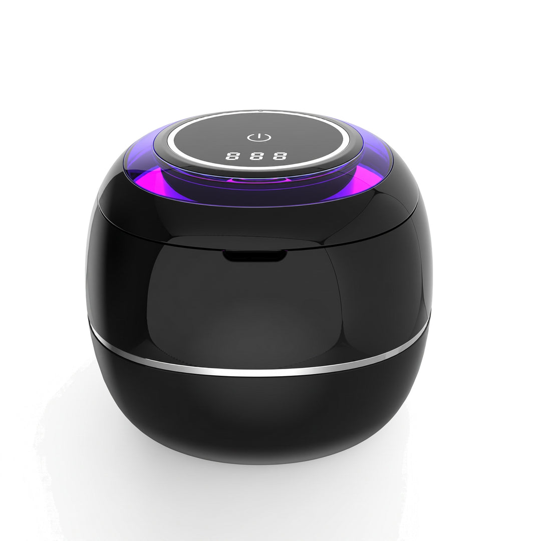 Ultrasonic retainer cleaner in black on a white background, lid closed with the digital display lit