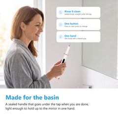 Ultrasonic tooth cleaner held at a bathroom basin, sealed handle that rinses under the tap