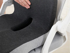 The centre cut-out through the seat of the memory foam back support cushion