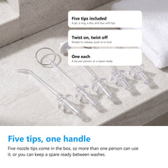 The five nozzle tips supplied with the cordless water flosser laid out on a bathroom shelf