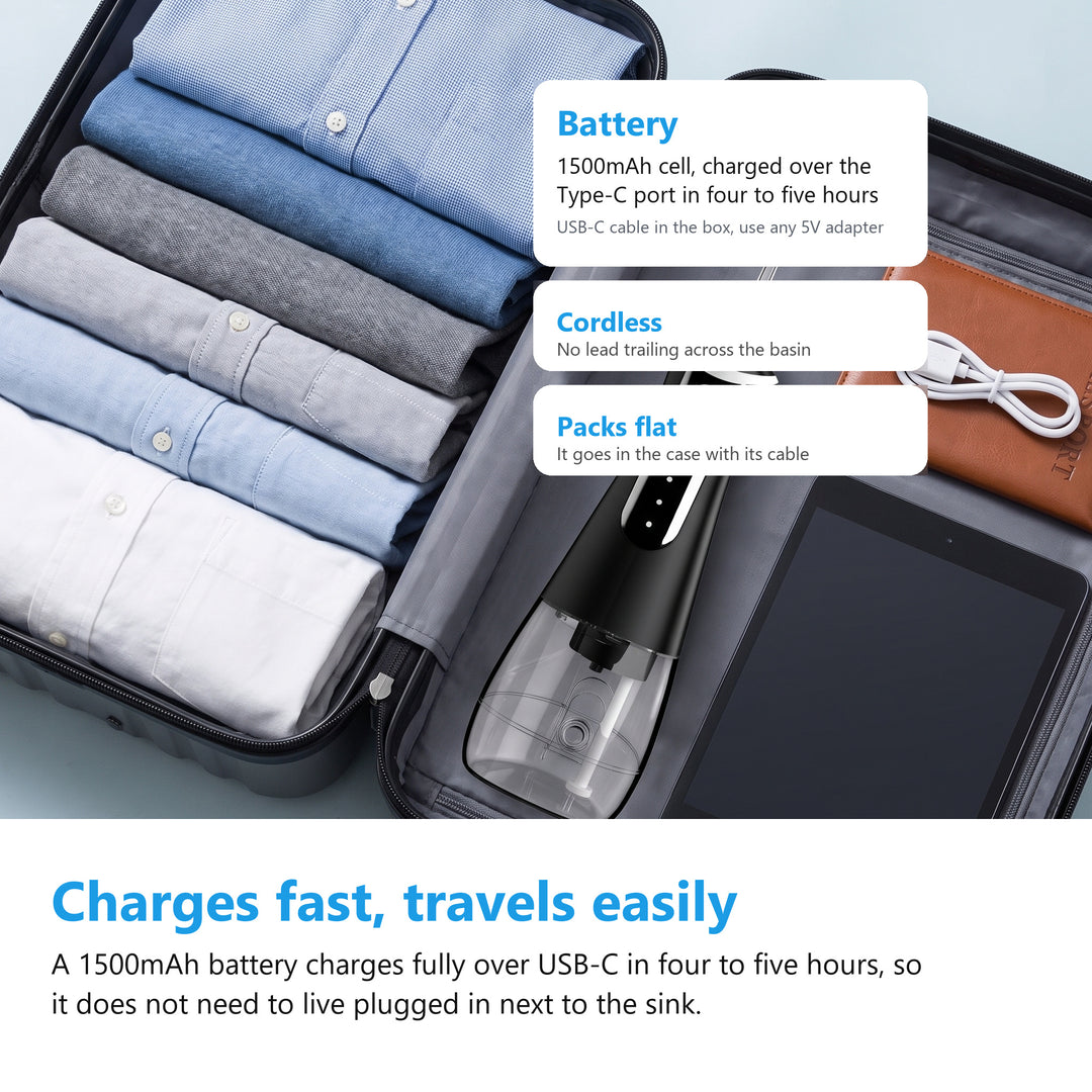Cordless water flosser and its USB-C charging cable packed in a suitcase