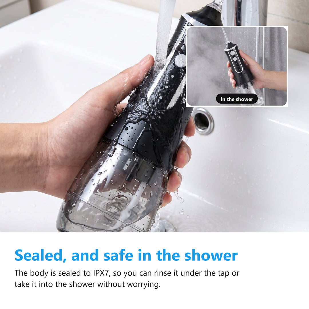 IPX7 cordless water flosser being rinsed clean under a running tap
