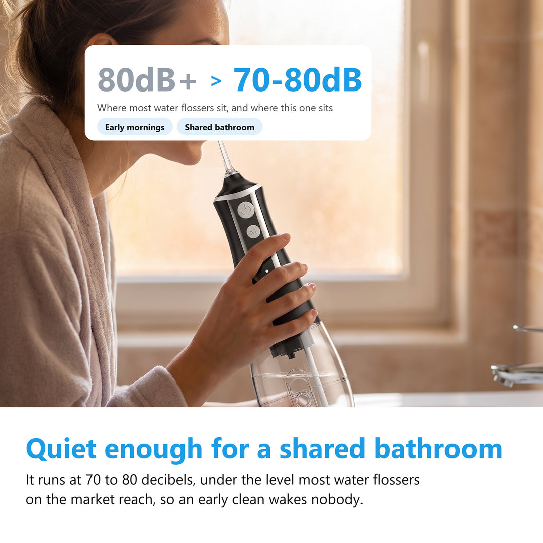 Woman using the cordless water flosser at a bathroom basin in morning light