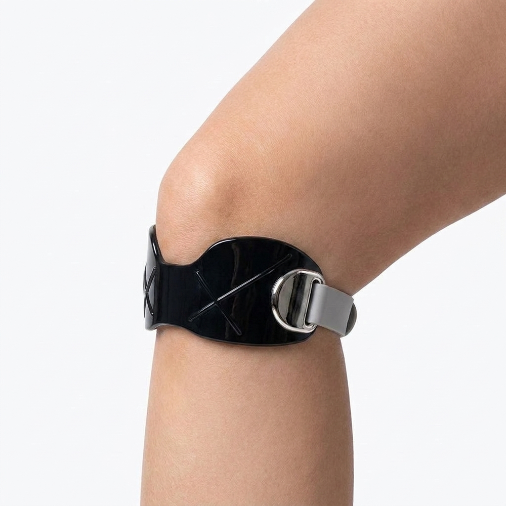 Two-tone black silicone patella band worn on the knee