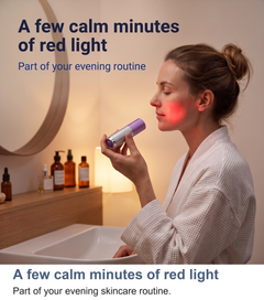 Woman using the red light torch as part of her evening skincare routine