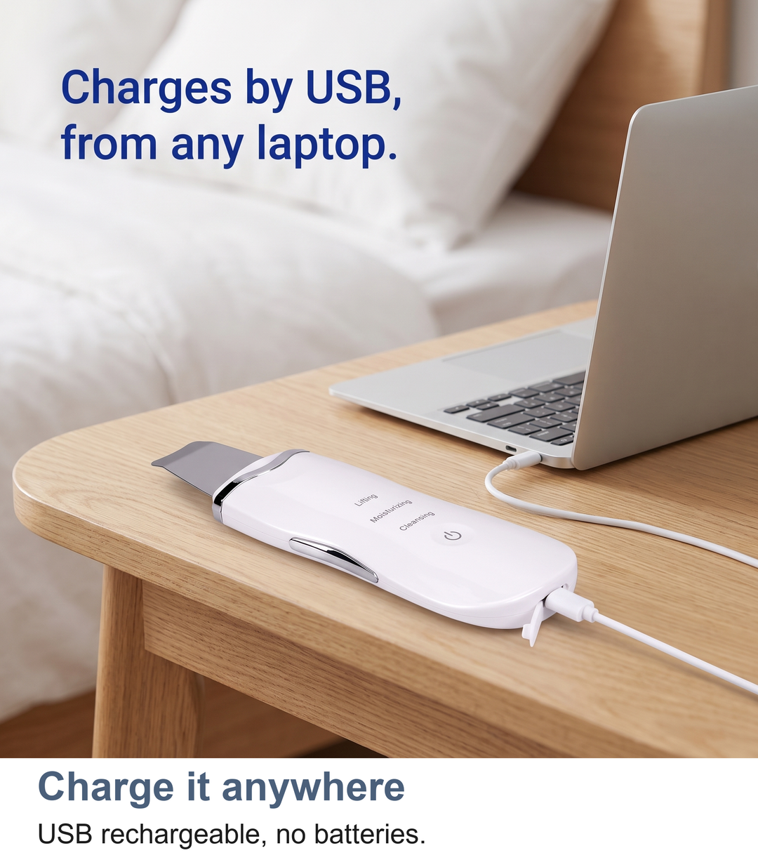 Ultrasonic skin scrubber charging by USB cable beside a bed