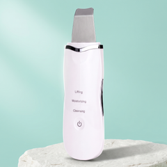 White ultrasonic skin scrubber with a flat metal head